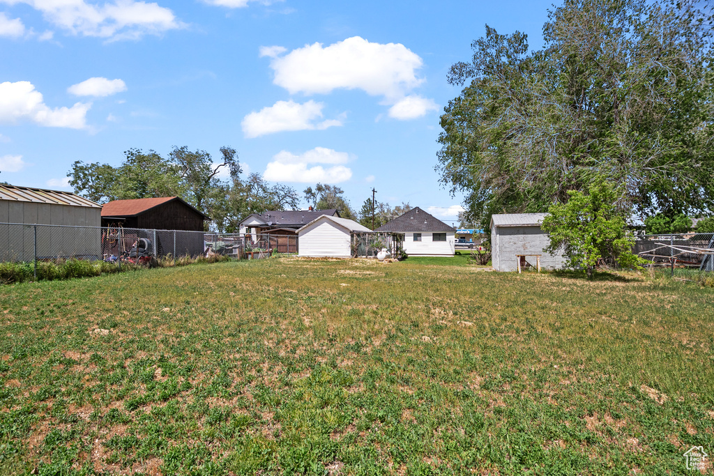 View of yard with a storage shed and an outbuilding