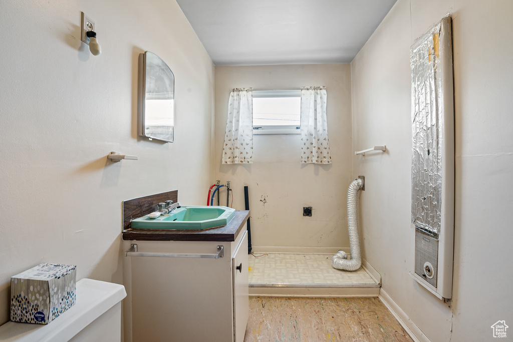 Bathroom with vanity, baseboards, and toilet