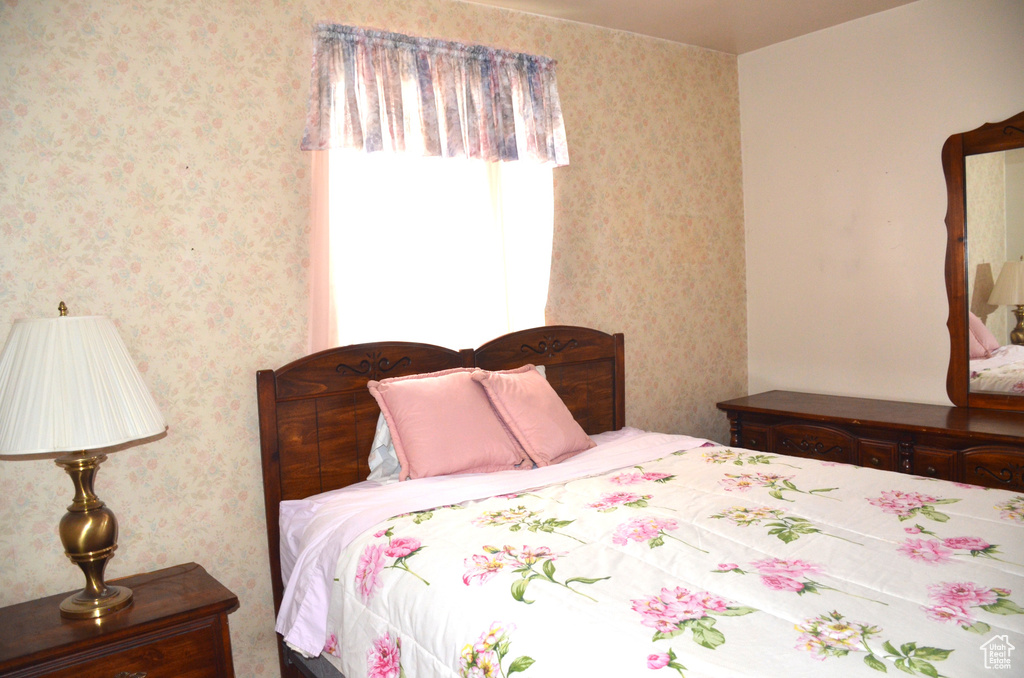 Bedroom featuring wallpapered walls