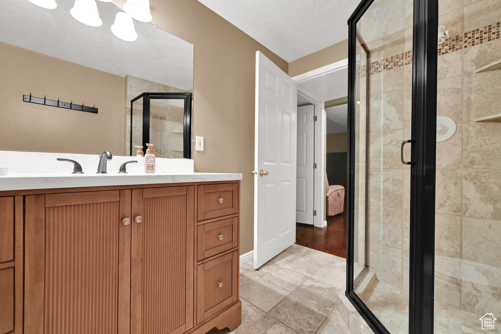 Full bath featuring a shower stall and vanity