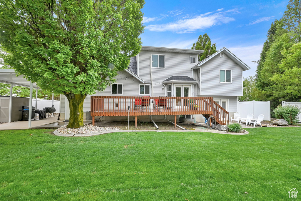 Back of house featuring a patio and a deck