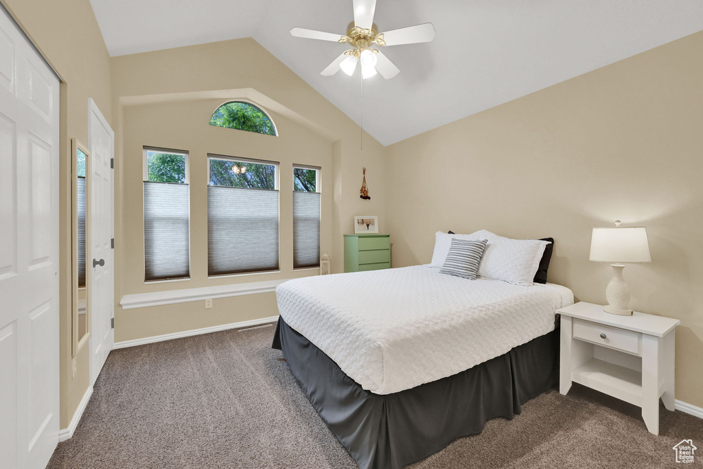 Bedroom with carpet flooring, vaulted ceiling, ceiling fan, and baseboards
