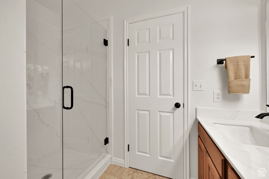 Bathroom with a marble finish shower and vanity