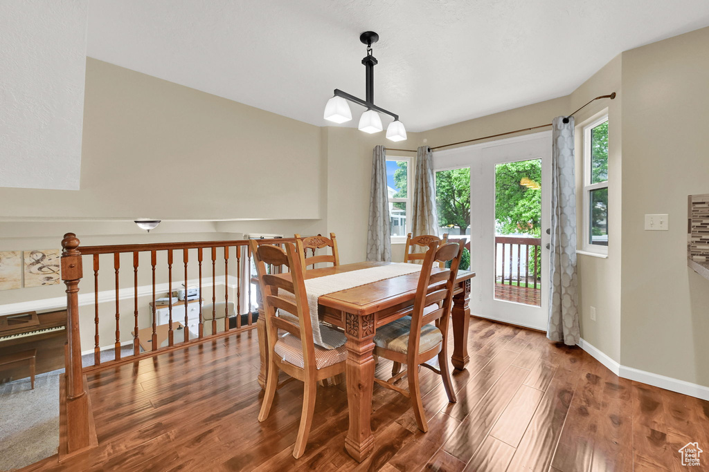 Dining space featuring wood finished floors, plenty of natural light, and baseboards
