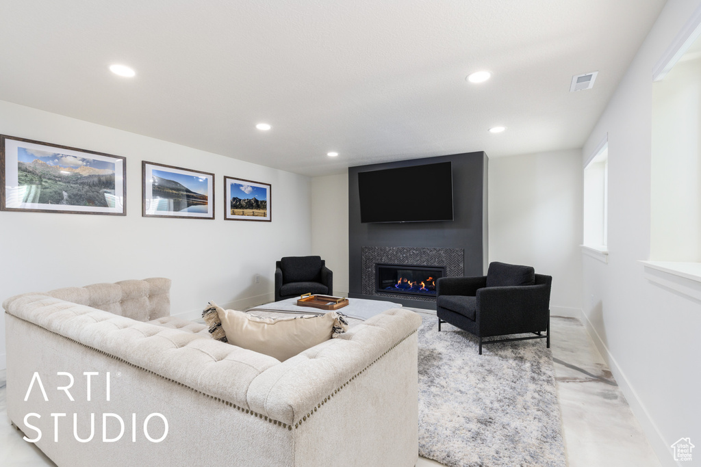 Living area featuring recessed lighting, a premium fireplace, and baseboards