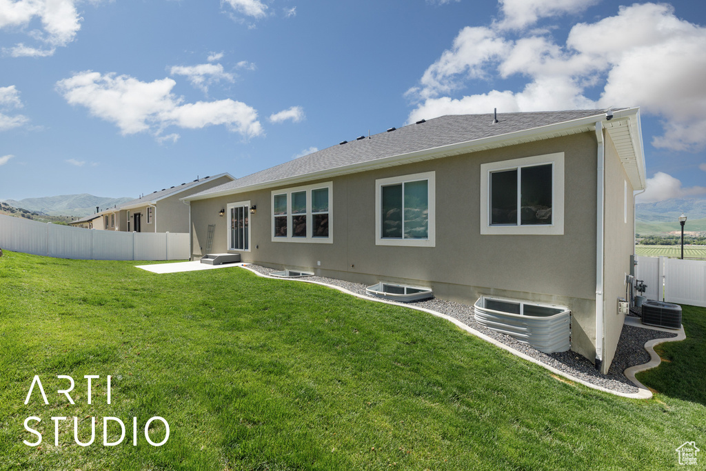 Back of property featuring a patio area and central AC