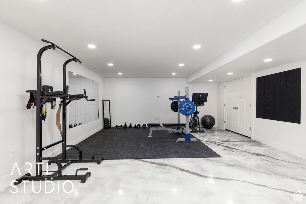 Exercise area with recessed lighting and baseboards