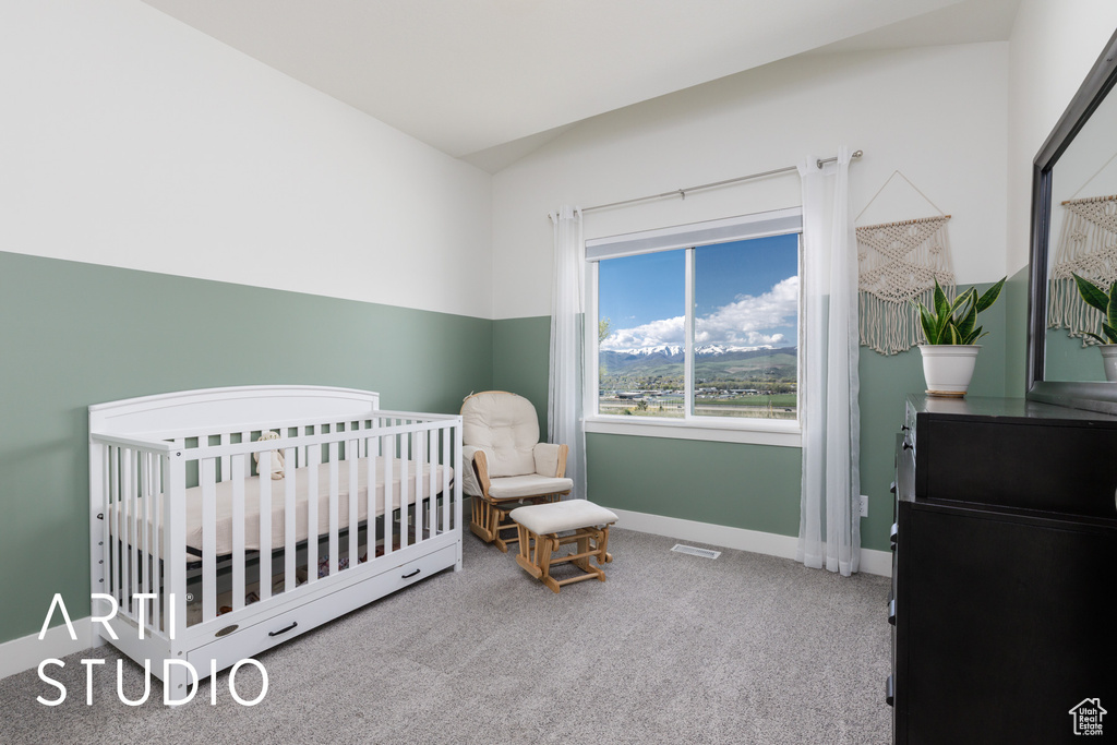 Bedroom featuring carpet floors, a nursery area, and baseboards