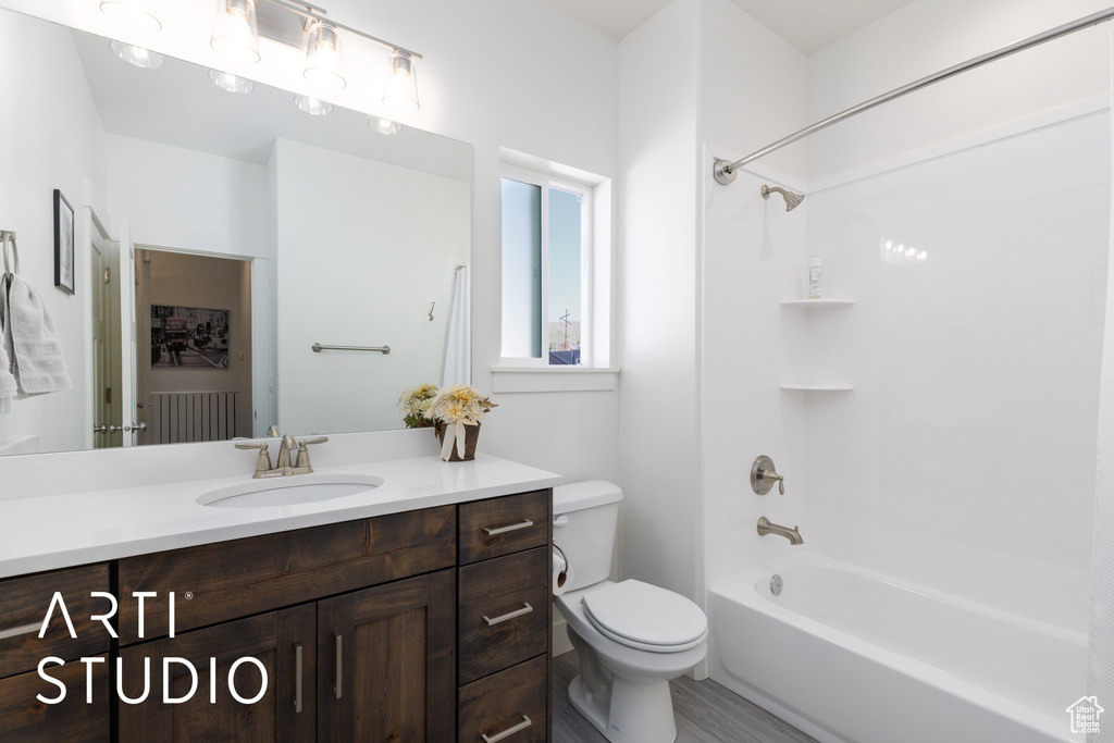 Bathroom with toilet, vanity, and shower / tub combination