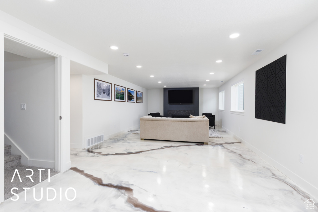 Living area with recessed lighting, stairs, and baseboards