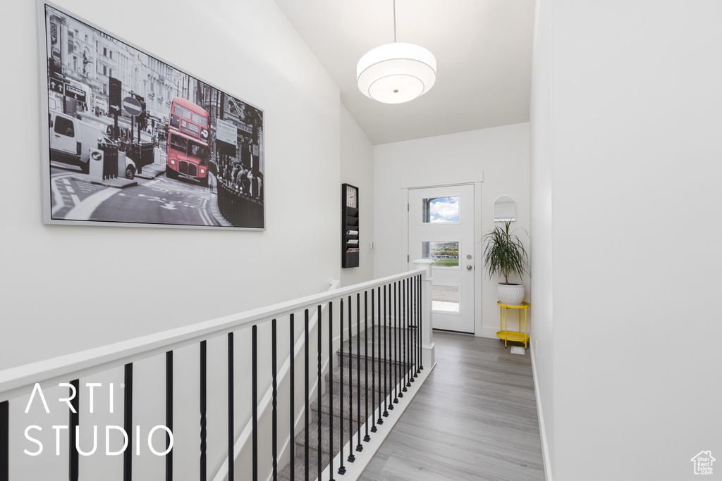 Corridor featuring wood finished floors and an upstairs landing