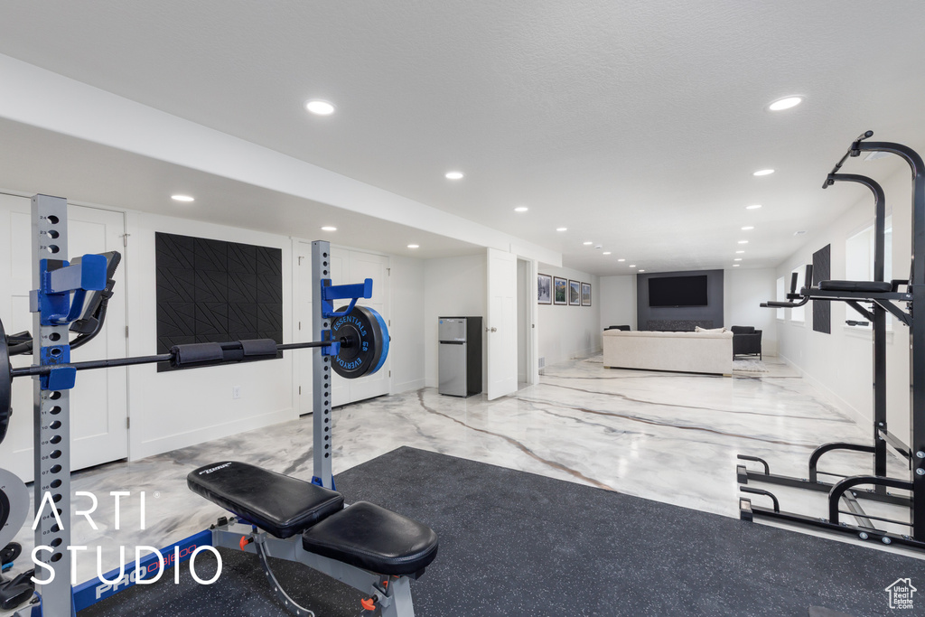 Workout area with recessed lighting and marble finish floors