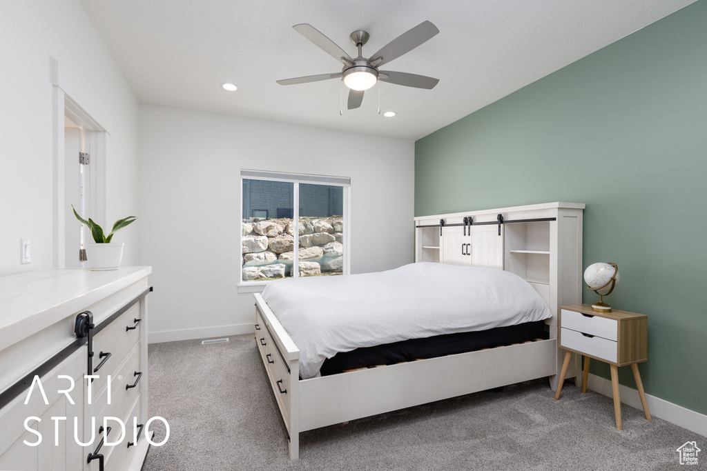 Carpeted bedroom featuring baseboards, recessed lighting, a ceiling fan, and a barn door