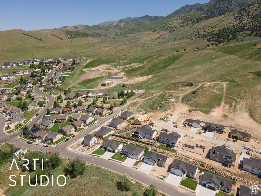 View of property location with mountains and nearby suburban area