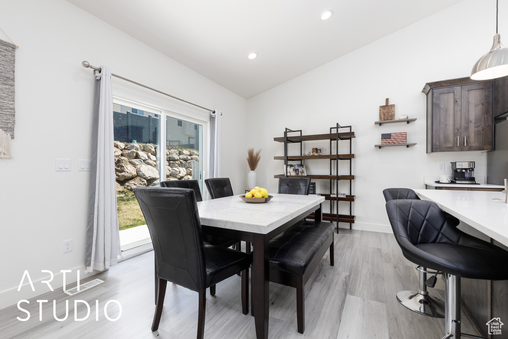 Dining area with light wood-type flooring, recessed lighting, baseboards, and lofted ceiling