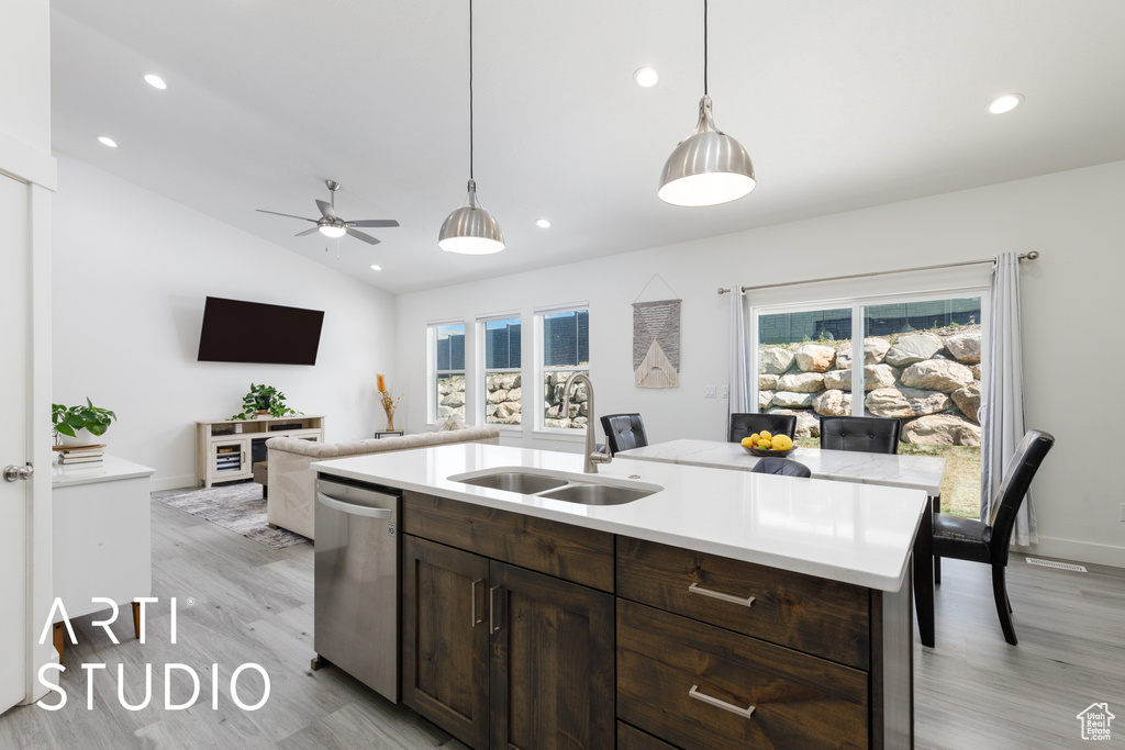 Kitchen with a sink, stainless steel dishwasher, light wood-style flooring, dark brown cabinetry, and recessed lighting