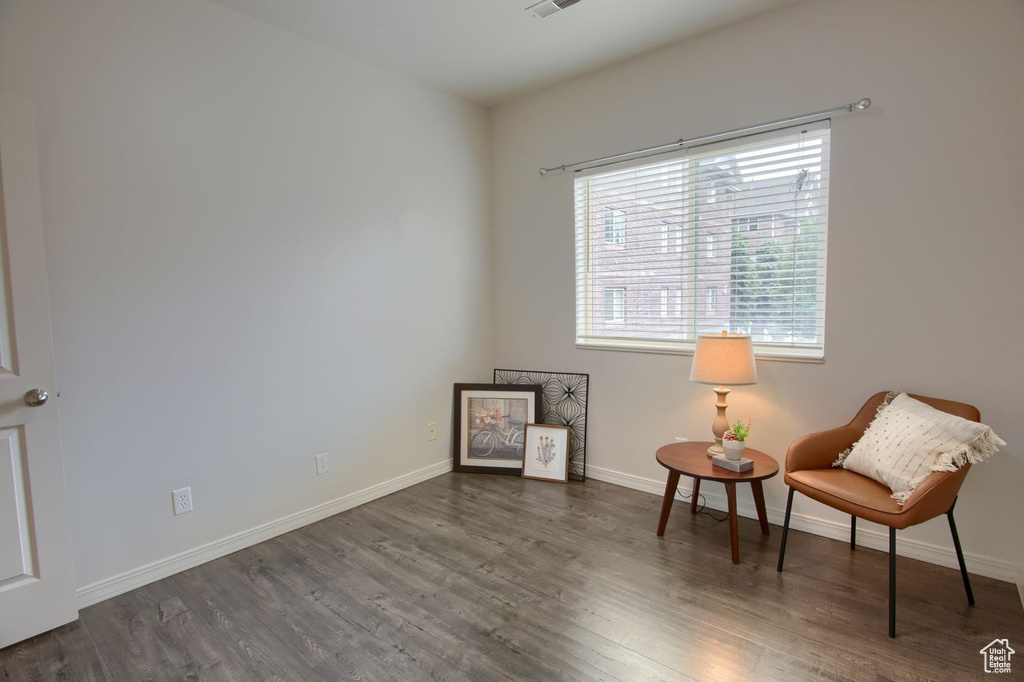 Living area with wood finished floors and baseboards