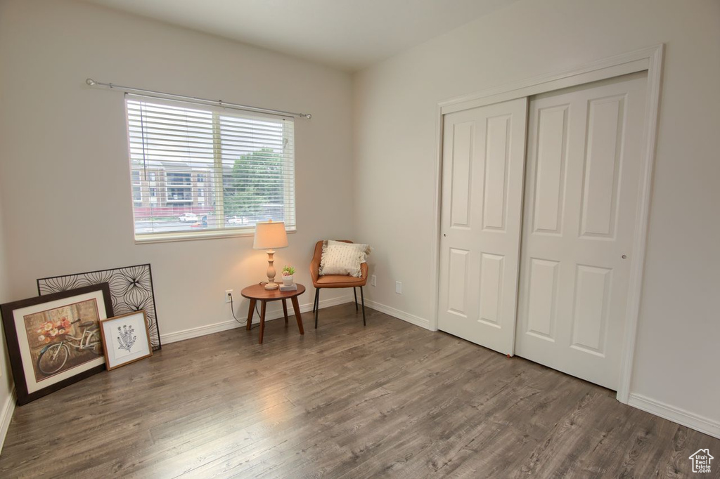 Living area with wood finished floors and baseboards