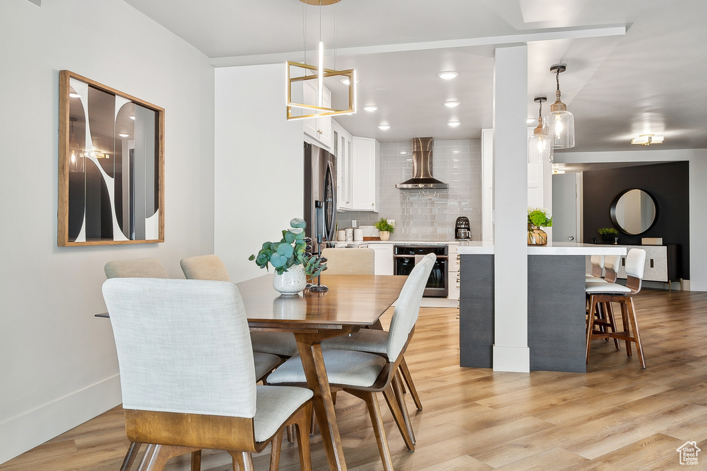 Dining area featuring light wood-style flooring and recessed lighting