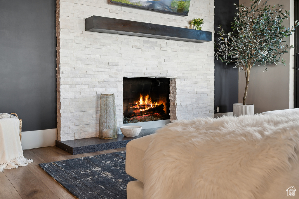 Bedroom with a fireplace and wood finished floors