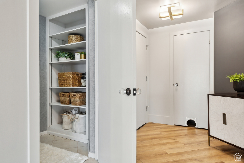 Hallway with light wood finished floors and baseboards