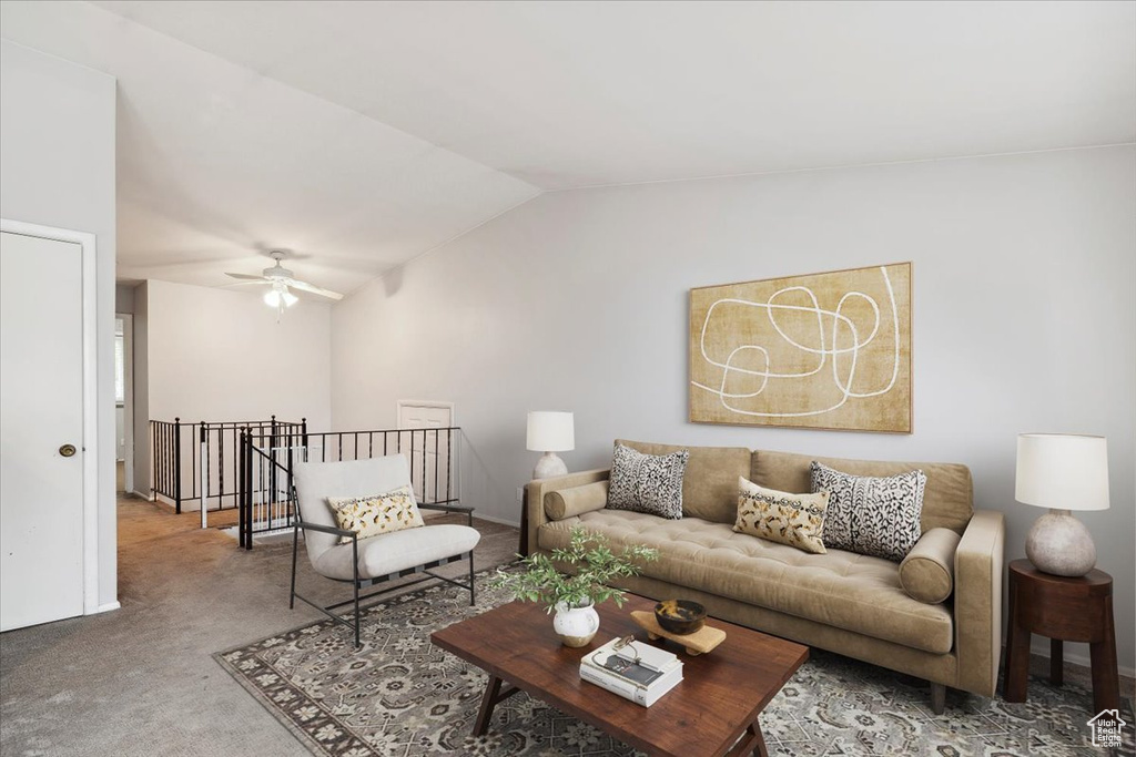 Carpeted living area with lofted ceiling and a ceiling fan