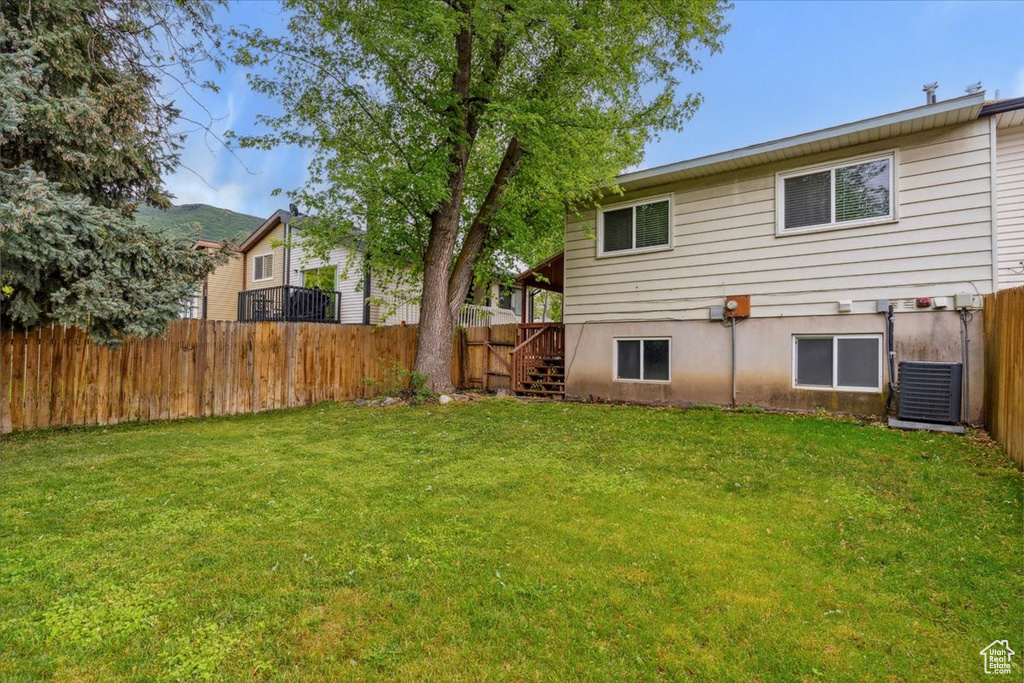 View of yard with central AC and stairs