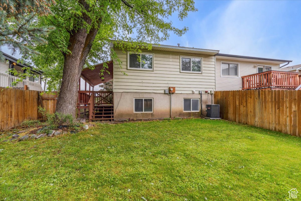 Rear view of property with stairs, a wooden deck, and central air condition unit
