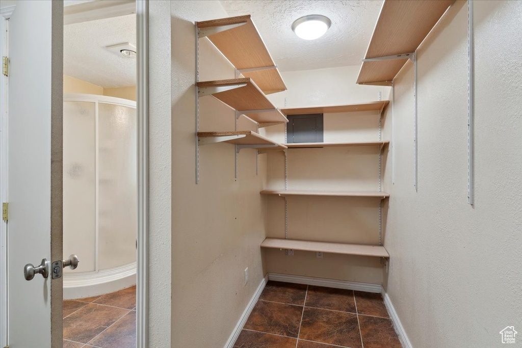 Walk in closet featuring tile patterned flooring