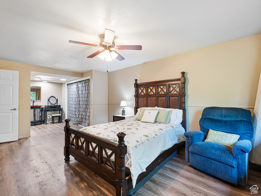 Bedroom featuring wood finished floors and a ceiling fan