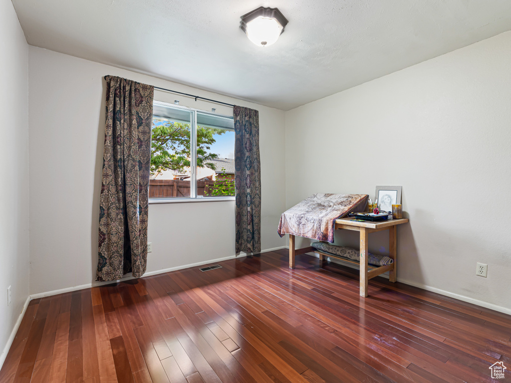 Office space with hardwood / wood-style floors and baseboards