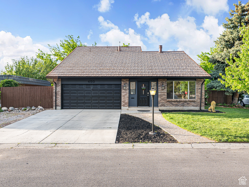 View of front of home featuring brick siding, an attached garage, and concrete driveway
