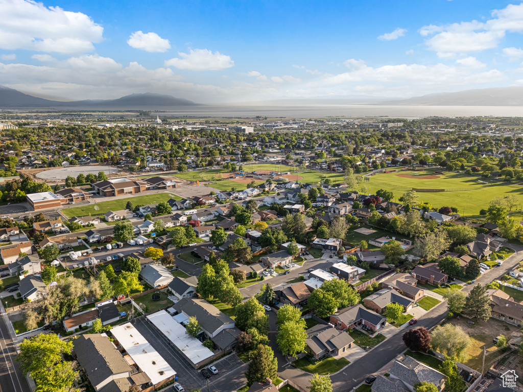 Aerial view of property's location featuring a mountainous background and nearby suburban area