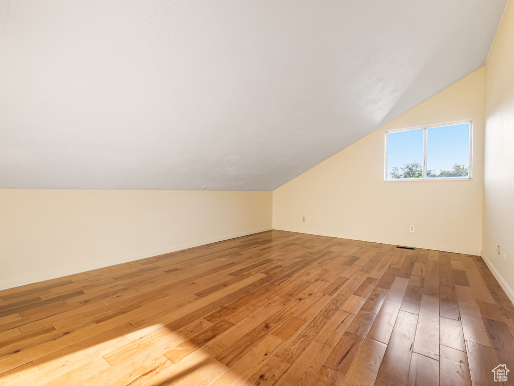 Bonus room featuring lofted ceiling and light wood finished floors
