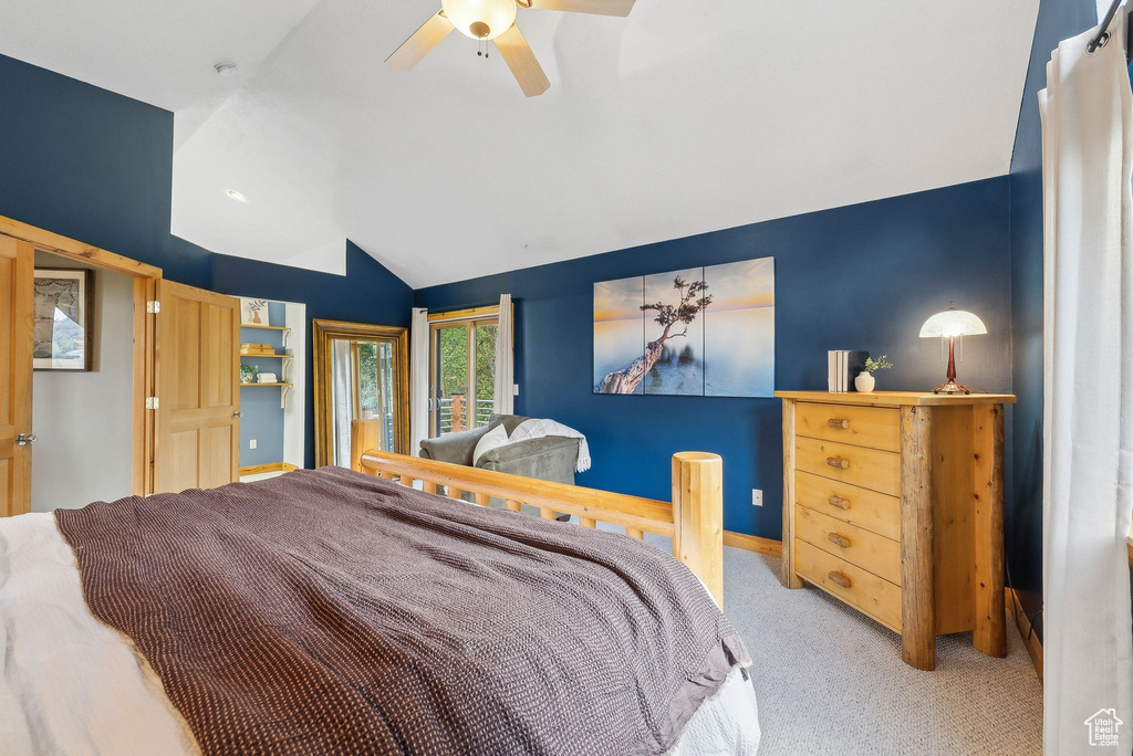Bedroom with vaulted ceiling, carpet floors, ceiling fan, baseboards, and access to outside