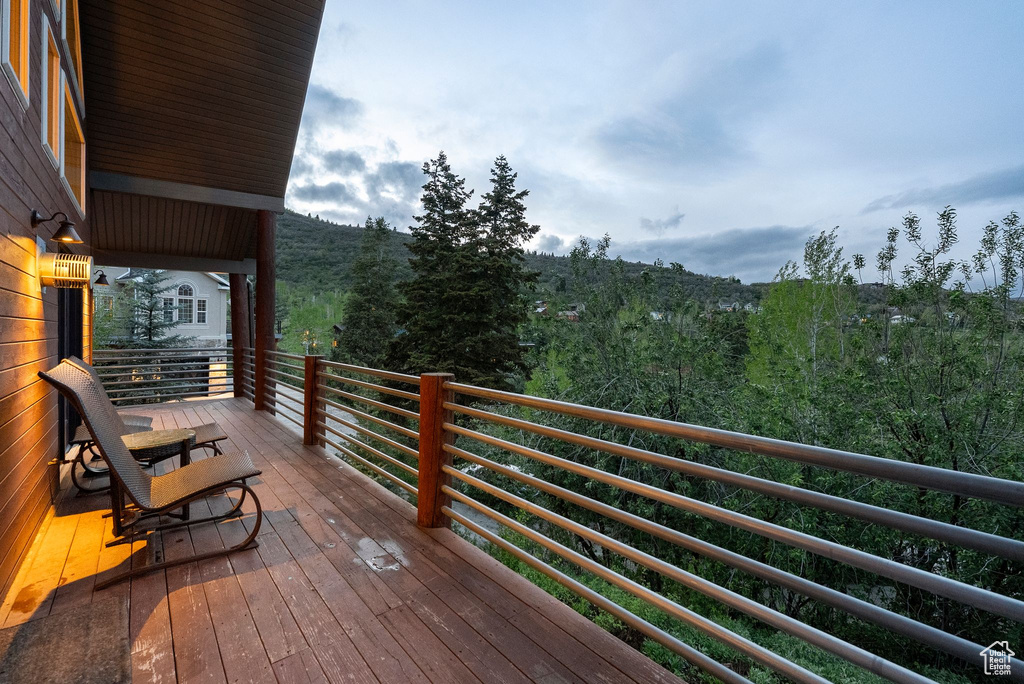 Wooden deck featuring a view of trees