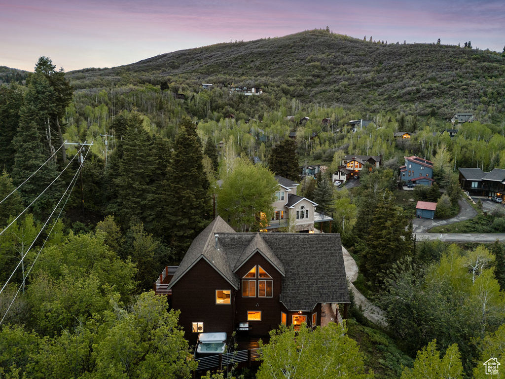 View of property location with a forest and a mountain backdrop