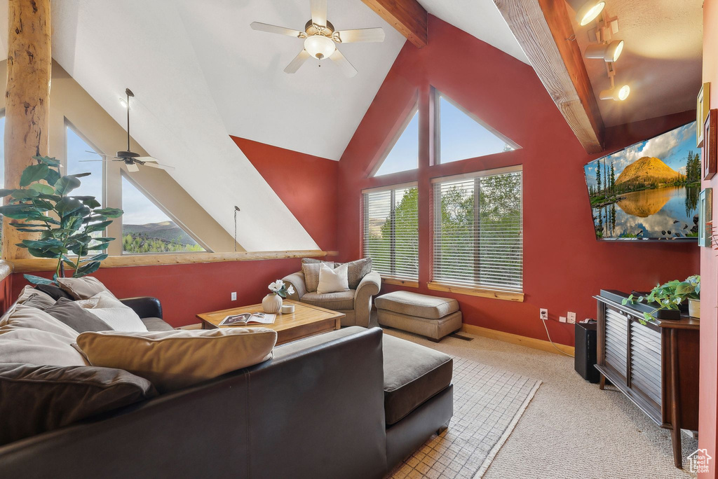 Living area featuring ceiling fan, plenty of natural light, light carpet, and baseboards