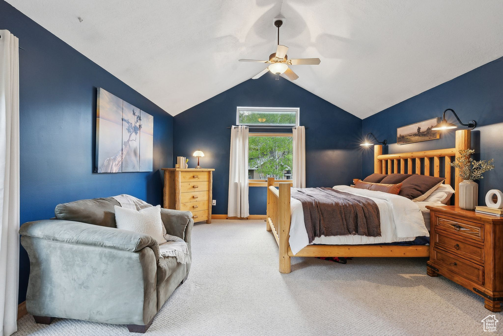 Bedroom featuring carpet flooring, vaulted ceiling, and a ceiling fan