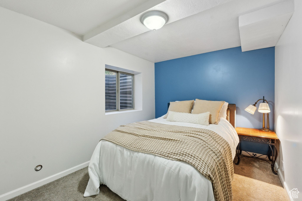 Bedroom featuring carpet floors and baseboards