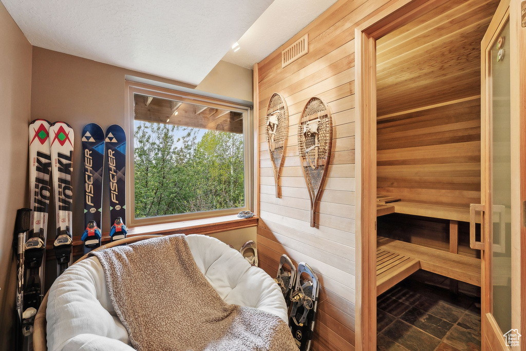 Sauna featuring wooden walls