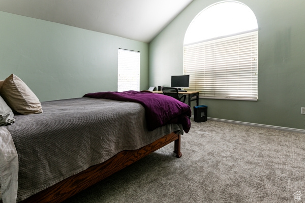 Bedroom with carpet and vaulted ceiling