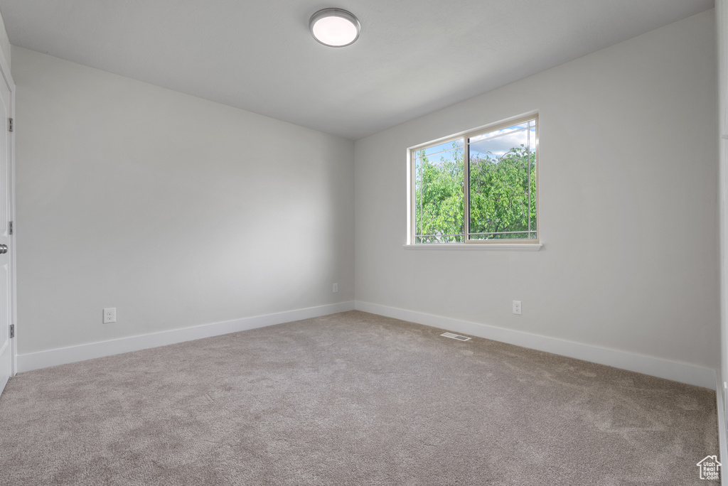 Unfurnished room featuring carpet flooring and baseboards