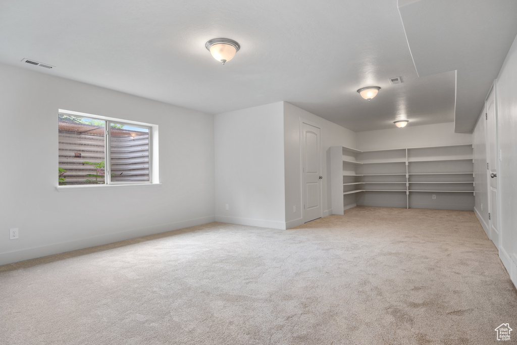 Empty room with carpet floors and baseboards
