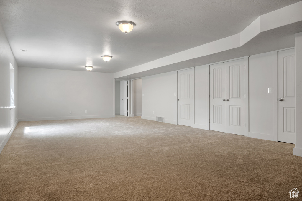 Below grade area featuring carpet and baseboards