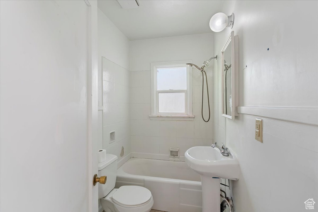 Full bathroom with toilet and tub / shower combination