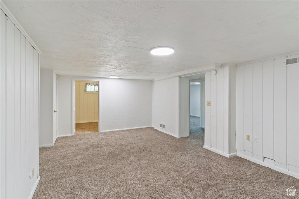 Basement featuring carpet floors and baseboards