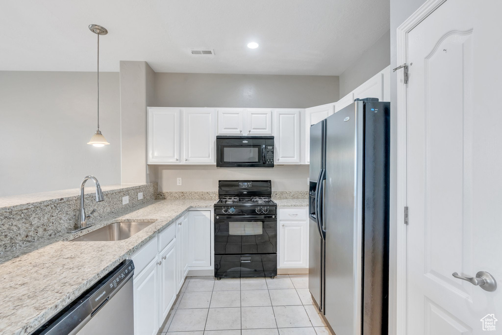 Kitchen with black appliances, a sink, white cabinetry, light tile patterned floors, and recessed lighting