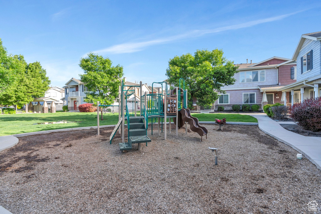 Communal playground with a residential view and a lawn