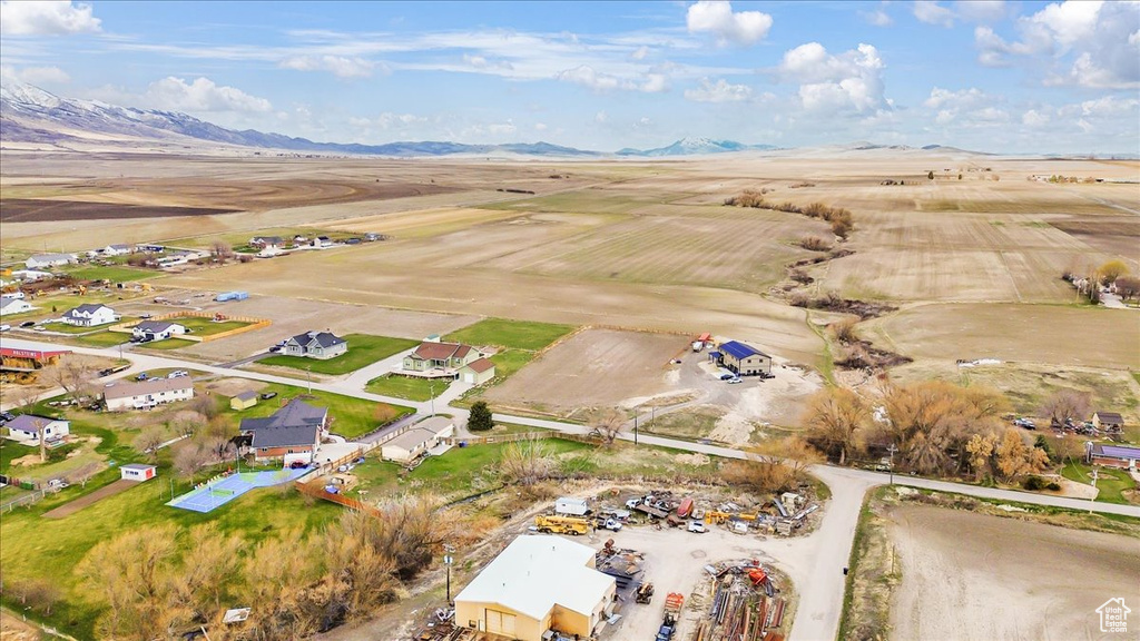 Aerial view of property and surrounding area featuring mountains